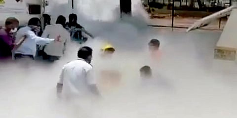 Hospital staff members running from the spot after an Oxygen tanker leaked while tankers were being filled at Dr. Zakir Hussain Hospital in Nashik. (Photo| ANI)