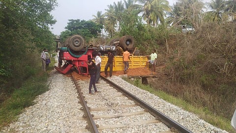The toppled over truck on the railway tracks. (Photo | Express)