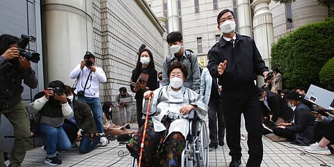 Former South Korean comfort woman Lee Yong-soo in a wheelchair leaves the Seoul Central District Court in Seoul. (Photo | AP)