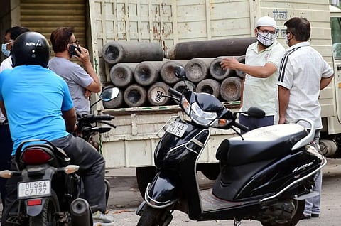 People enquire about availability of cylinders of medical oxygen, required for treatment of critical COVID-19 patients, as coronavirus cases surge across the country, in New Delhi. (Photo | PTI)