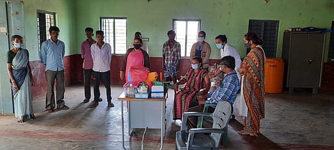 Tribals queue up for vaccination at Nagapura hamlet outreach centre in Hunsur taluk, Mysuru. (Photo | Express)