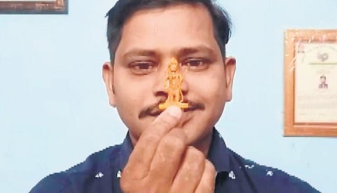 Satya Maharana holding the miniature idol of Lord Ram | Express