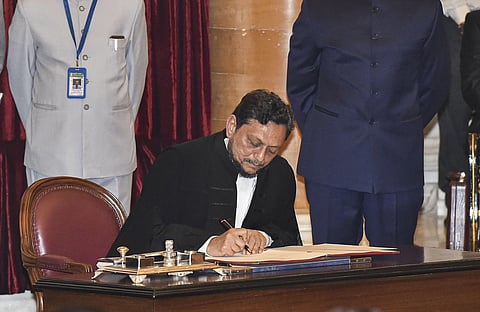 Justice Sharad Arvind Bobde signing on a register after taking oath as the 47th CJI in 2019. (File photo | PTI)