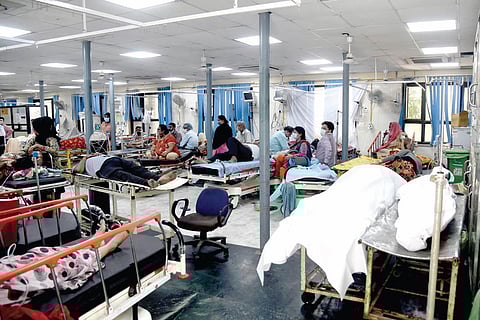 Patients rest in a Covid-19 ward while two dead bodies are kept nearby at the GTB hospital on Thursday. (Photo | EPS/Parveen negi)
