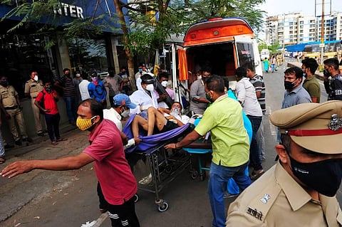 A Covid-19 pateint being taken out of a hospital after a fire in Vasai, Maharashtra, Friday. April 23, 2021. (Photo | PTI)