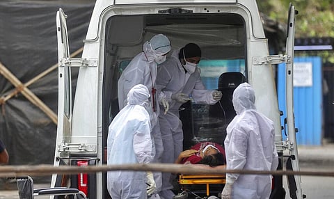 Health workers attend to a patient at the Jumbo COVID-19 filed hospital in Mumbai, India, Thursday, April 22, 2021. (Photo | AP)