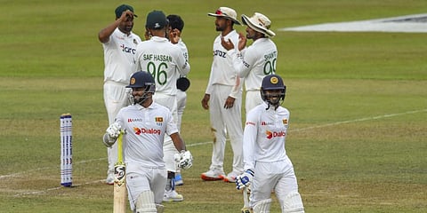 Sri Lanka's Dimuth Karunaratne (L) and Dhananjaya de Silva (R) walk back to the pavilion at the end of Day 3 of the 1st Test match against Bangladesh in Pallekele. (Photo| AFP)
