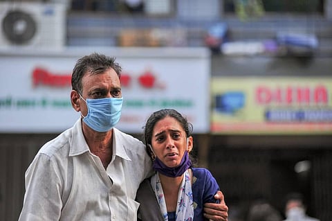Family members react after a fire at a Covid-19 hospital where at least 13 people died, in Virar. (Photo | PTI)