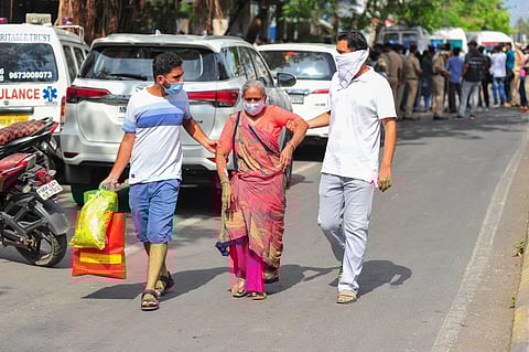 A Covid-19 pateint being taken out of a hospital after a fire in Virar, Friday, April 23, 2021. (Photo | PTI)