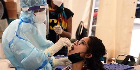 A health worker in PPE kit collects a swab sample. (Photo | Parveen Negi, EPS)