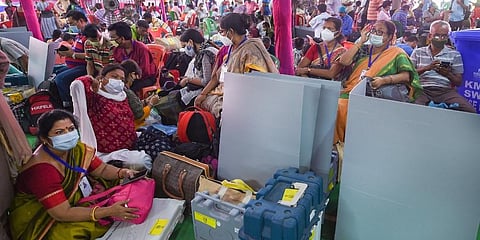 Polling officials with their Electronic Voting Machines (EVM) and other election materials on the eve of 7th phase of the West Bengal Assembly polls. (Photo | PTI)