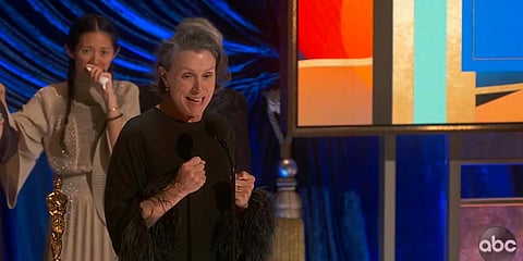 Frances McDormand accepts the best picture award for 'Nomadland' as director Chloe Zhao looks on at the Oscars. (Photo| AP)