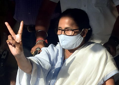 West Bengal CM Mamata Banerjee shows victory signs after cast her vote at a polling station in Kolkata on Monday. (Photo | ANI)