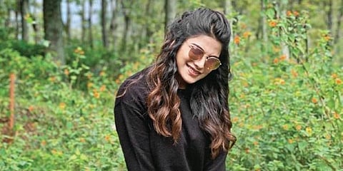 Aathmika at the shooting spot of 'Kodiyil Oruvan'.