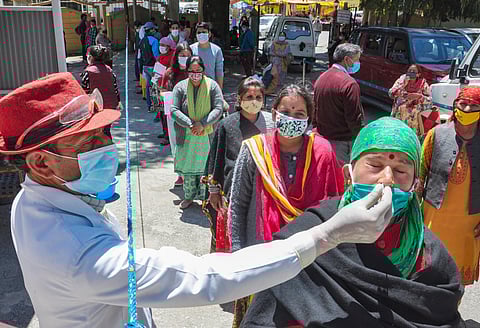 A health worker collects samples for Covid-19 tests. (Photo | PTI)