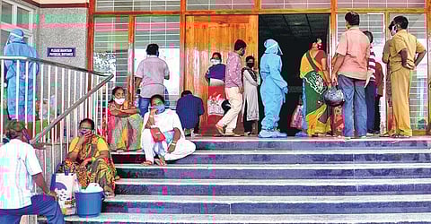 Family members of Covid-19 patients wait outside KGH in Vizag. (Photo | G Satyanarayana, EPS)