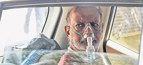 A Covid-positive patient on oxygen support waiting for admission in a car outside the Lok Nayak Jai Prakash Narayan Hospital in Delhi on Monday | Parveen Negi