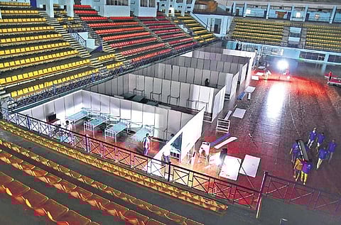 A file photograph of beds being set up at a Covid Care Centre at the Koramangala Indoor Stadium in Bengaluru | Express