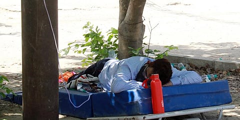 A COVID-19 patient breathes with the help of an oxygen cylinder by a NGO that are offering free cylinders in Gurugram. (Photo | ANI)