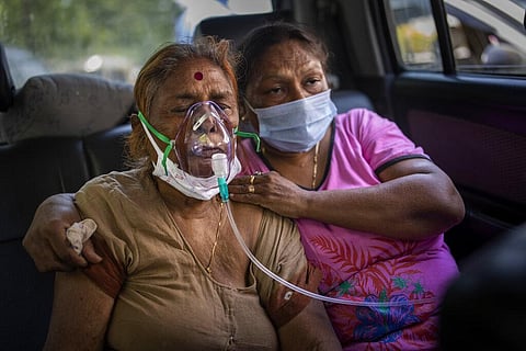 A COVID-19 patient inside a car, receives oxygen provided by a Gurdwara, a Sikh house of worship, in New Delhi. (Photo | AP)