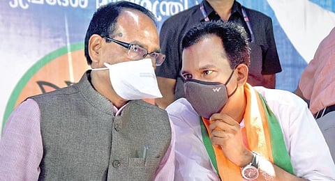 Madhya Pradesh CM Shivraj Singh Chouhan shares a light moment with BJP’s Beypore candidate Prakash Babu at Naduvattom in Kozhikode on Friday | Express