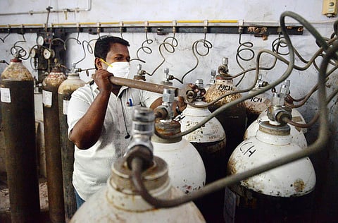 S Justin Raj, a technician at the Medical College Hospital in T’Puram, filling oxygen in a cylinder at an adjacent plant. (Photo | Vincent Pulickal, EPS)