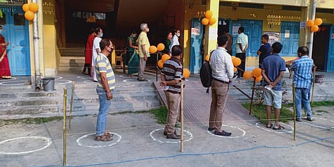 Voters queue up outside a polling station in Assam's Kokrajhar. (Photo| EPS