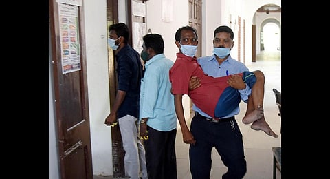 A man carrying a physically challenged person to cast his vote at Lady Wellington School, Triplicane, in Chennai. (Photo | R Satish Babu, EPS)