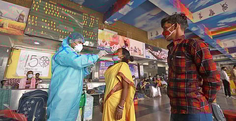 A health worker takes sample from a women for COVID-19 test, as coronavirus cases surge across the country, at New Delhi Railway Station in New Delhi. (Photo | Shekhar Yadav)