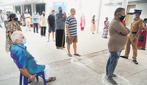 People wait to cast votes at one of the booths following social distancing. (Photo | R Satish Babu, EPS)