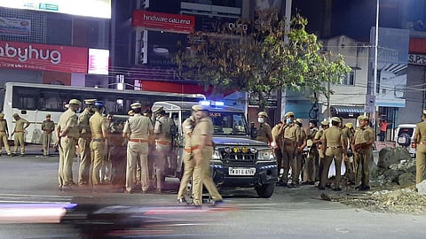 Police personnel deployed at Velachery-Taramani road after two people were grilled by the public for carrying EVMs | Ashwin Prasath