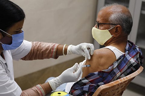 An elderly man receives the vaccine for COVID-19 at Moti Lal Nehru Medical College in Prayagraj. (Photo | AP)