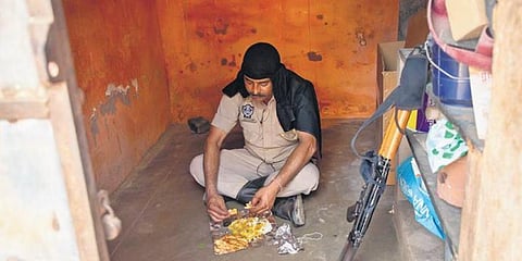 A paramilitary personnel having lunch near a booth in Puduchery. (Photo | G Pattabi Raman/EPS)