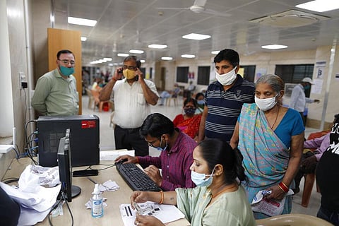 People wait to register themselves to receive the vaccine for COVID-19 at Moti Lal Nehru Medical College in Prayagraj. (Photo | AP)