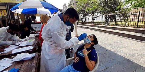A medic collects a nasal sample of a woman for Random Antigen COVID-19 testing. (Representational Photo | ANI)