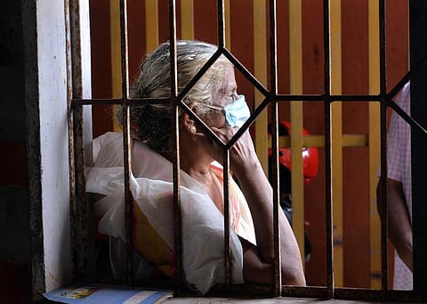 An elderly woman waiting at General hospital in Thiruvananthapuram to get vaccinated. (Photo | EPS)