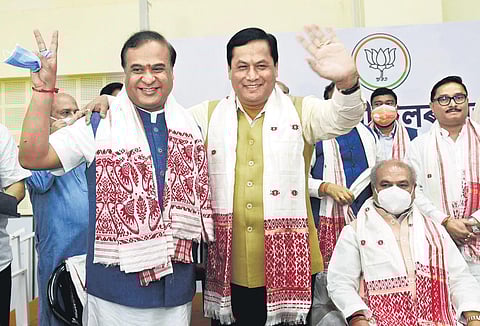 Chief Minister Himanta Biswa Sarma (left) being greeted by former Assam Chief Minister Sarbananda Sonowal in Guwahati/ (File Photo | PTI)