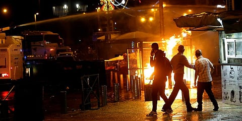 An Israeli police water cannon is deployed near the Damascus Gate to the Old City of Jerusalem as a fire burns during clashes between police and Palestinian protesters. (Photo | AP)