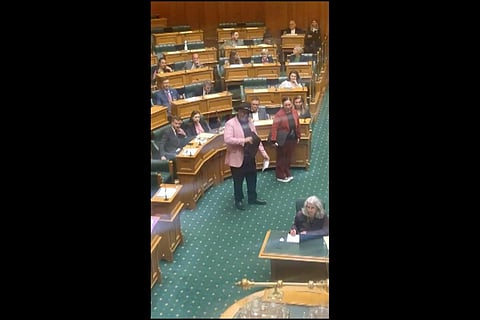 ndigenous New Zealand lawmaker Rawiri Waititi, center, performs a Maori haka in Parliament in Wellington on Wednesday. (Photo | AP)
