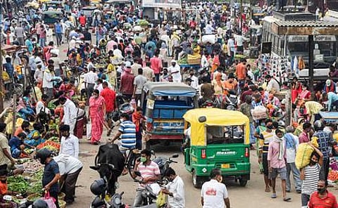 People, ignoring social distancing norms, gather at a market to buy essential items, amid a COVID-induced lockdown, in Patna, Tuesday, May 11, 2021. (Photo | PTI)