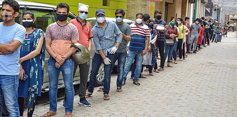 Beneficiaries wait in a queue to recieve COVID-19 vaccine dose at a health centre. (Photo | PTI)