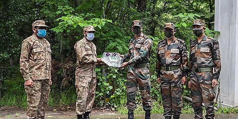 Indian Army officers exchange sweets with Pakistan Army officers, on the auspicious occasion of Eid-ul-Fitr at LOC at Poonch-Rawlakot and Mendhar Hotspring (Tatapani) check posts. (Photo | PTI)