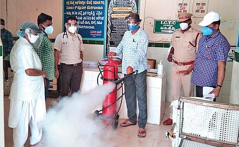 Fire services personnel hold a demonstration on fire safety at a government hospital in Prakasam district on Wednesday | express