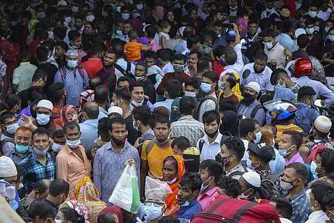 Thousands of people leaving for their native places to celebrate Eid-al-Fitr throng the Mawa ferry terminal ignoring risks of coronavirus infection in Munshiganj, Bangladesh. (Photo | AP)