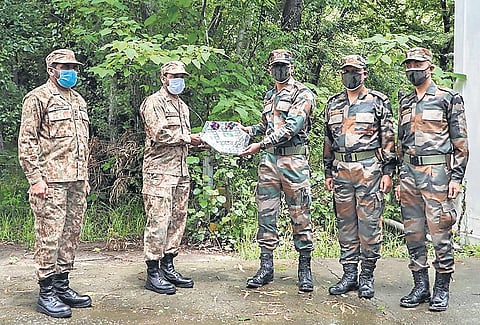 Indian Army officers exchange sweets with Pakistan Army officers at Poonch-Rawlakot and Mendhar Hotspring (Tatapani) check post. (Photo | PTI)