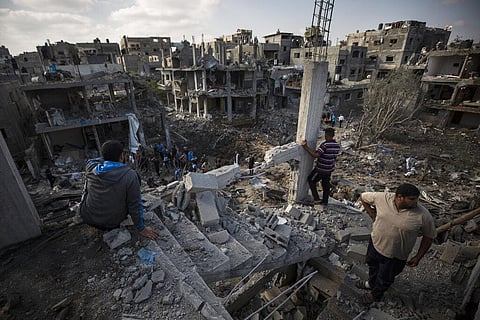 Palestinians inspect their destroyed houses following overnight Israeli airstrikes in town of Beit Hanoun, northern Gaza Strip, Friday. (Photo | AP)