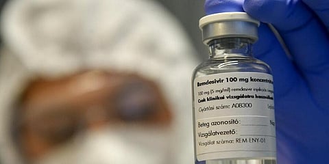 A bottle containing the drug Remdesivir is held by a health worker. (File Photo | AP)