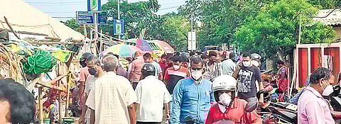 Locals crowd the fish market at Berhampur on the eve of the weekend shutdown I Express