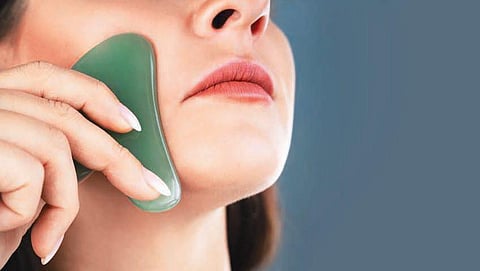 During a Gua Sha—pronounced gwashah—the practitioner makes scraping motions on your face in upward strokes with a flat piece of jade or rose quartz.