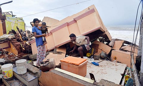 A man searches for his belongings amid debris of his house at Kochuthope coastal village in Thiruvananthapuram following sea erosion. (Photo| Vincent Pulickal, EPS)